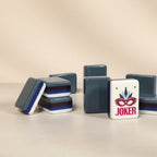 American mahjong tiles in grey acrylic with a decorative joker tile featuring a mask design