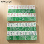American mahjong tiles with jade green marbled backs and engraved bamboo and flower designs