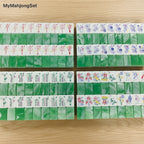 American mahjong tiles in jade green marble pattern with detailed colorful engravings