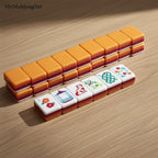 MyMahjongSet acrylic mahjong tiles featuring a modern color-blocked design in orange, red, and white on a wood table.