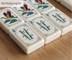 MyMahjongSet luxury acrylic American mahjong tiles featuring elegant yellow crane and bamboo patterns on a wooden table.