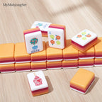 MyMahjongSet acrylic mahjong tiles with colorful floral designs and layered orange, pink, and white edges.