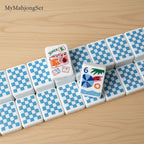Blue and white gingham checkered American mahjong tile backs with colorful vacation-themed fronts