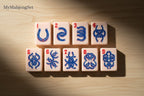 MyMahjongSet luxury acrylic mahjong tiles featuring western cowboy horseshoe designs in blue and red on pink tiles