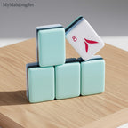 MyMahjongSet American mahjong tiles in durable acrylic with a green dragon-engraved finish stacked on a wooden surface.
