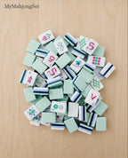 MyMahjongSet American mahjong tiles featuring green dragon engravings and colorful motifs on durable acrylic pieces.