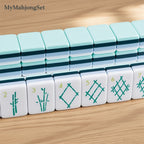 MyMahjongSet American mahjong tiles with green engraved bamboo motifs on durable white and light blue acrylic.