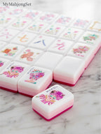 MyMahjongSet modern magenta candy pattern acrylic American mahjong tiles with colorful illustrations on a marble surface
