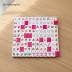 MyMahjongSet modern magenta candy pattern acrylic American mahjong tiles arranged in a square on a wooden table.