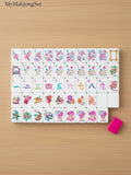 MyMahjongSet modern magenta candy pattern acrylic American mahjong tiles with colorful illustrations on a wooden table.