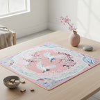 Pink American mahjong mat featuring crane and cherry blossom patterns, styled on a wooden game table
