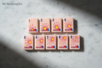 MyMahjongSet pink acrylic American mahjong tiles featuring a western ranch sunrise design with numbered barns