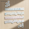 MyMahjongSet 160-piece American mahjong tile set with white pearl acrylic finish and floral-inspired engravings.