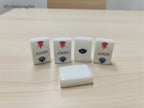 MyMahjongSet white pearl acrylic American mahjong tiles featuring Joker and flower designs on a wooden table