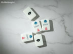 MyMahjongSet white pearl acrylic American mahjong tiles with Joker and floral designs on a marble surface