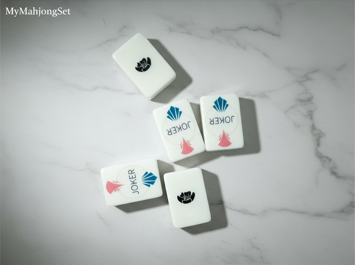 MyMahjongSet white pearl acrylic American mahjong tiles with Joker and floral designs on a marble surface