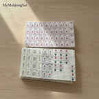 MyMahjongSet American mahjong tiles with a white pearl finish, featuring engraved characters and symbols.